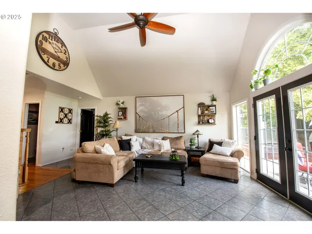 a living room with furniture and a floor to ceiling window