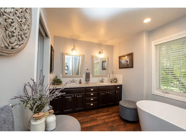 a bathroom with a bathtub a sink and a large mirror