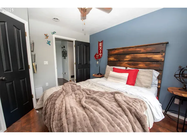 a bedroom with a bed and a large mirror