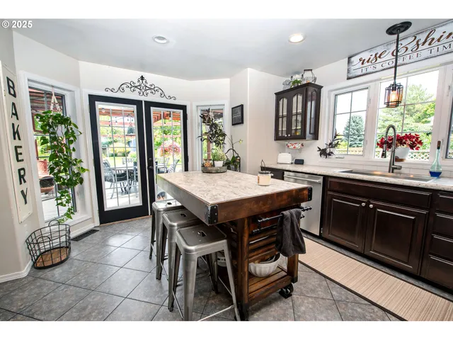 a kitchen with a sink and chairs