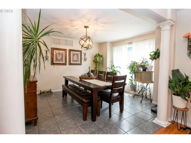a dining room with furniture and a chandelier