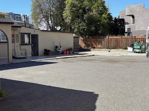a view of a house with backyard and sitting area