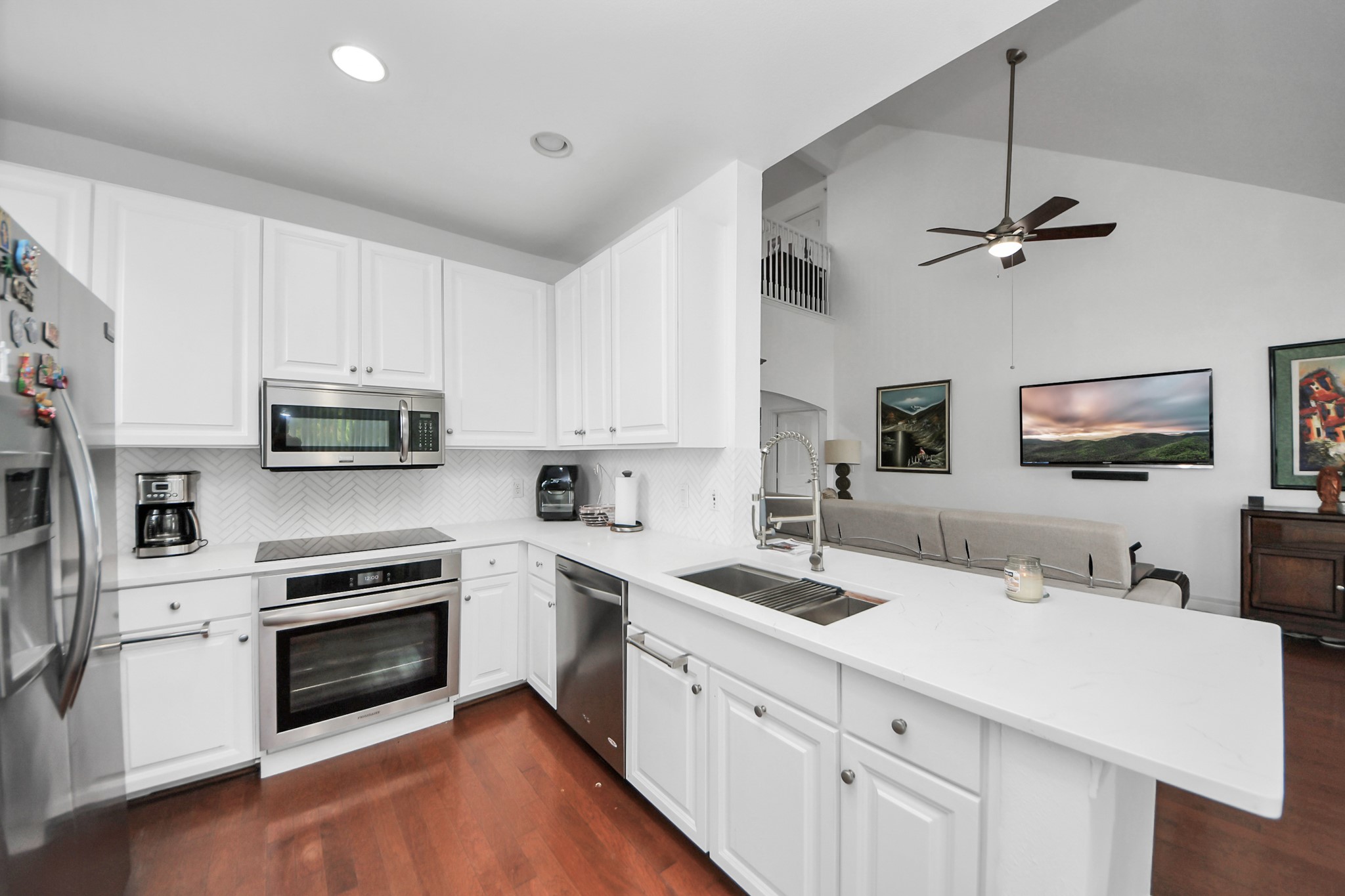 2400 McCue Road, Unit 424 Houston, TX 77056 - Photo 12 of 33 a kitchen with stainless steel appliances a stove a sink and white cabinets