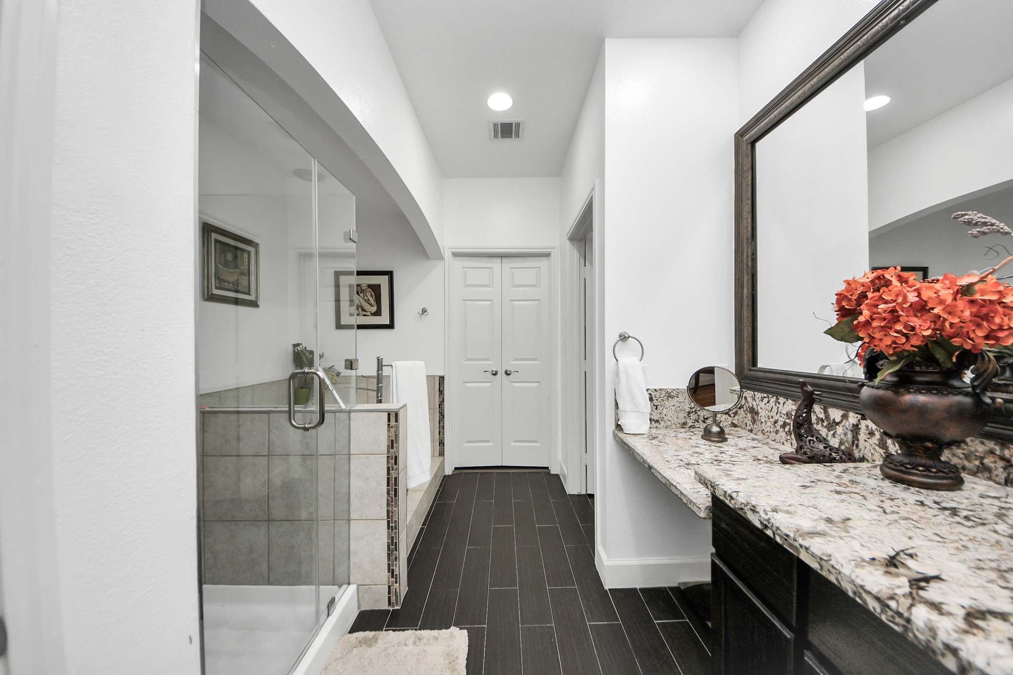 2400 McCue Road, Unit 424 Houston, TX 77056 - Photo 16 of 33 a spacious bathroom with a granite countertop sink a mirror and shower
