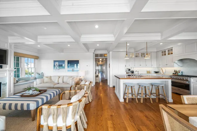 a living room with furniture fireplace and a large window