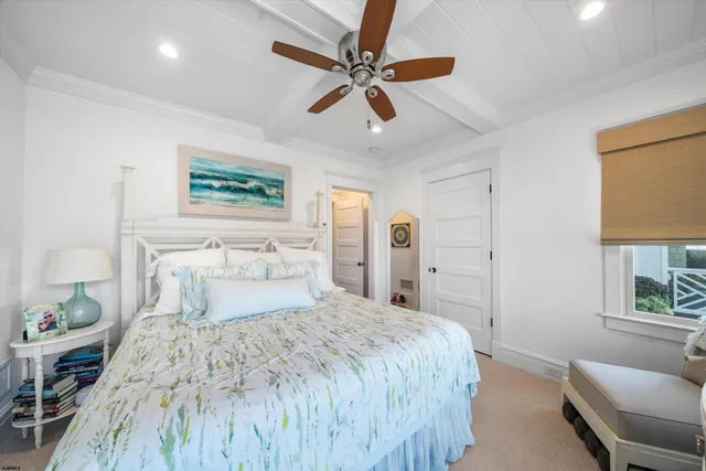 a bedroom with a bed a couch and window