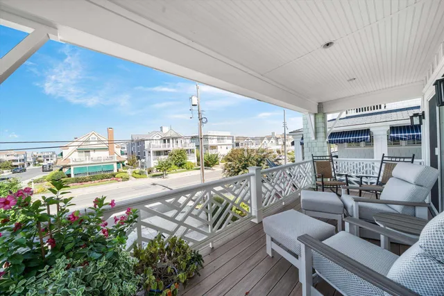 a bedroom with a balcony a bed and a chandelier