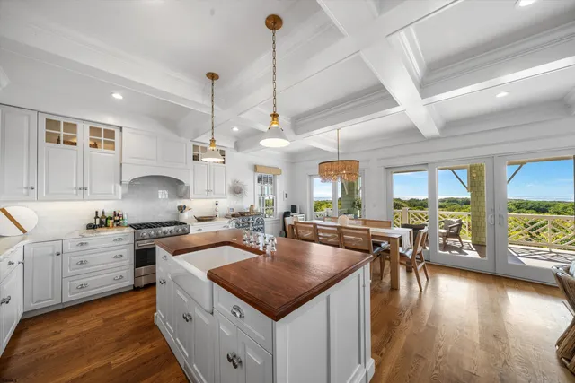 a dining room with furniture a chandelier and wooden floor