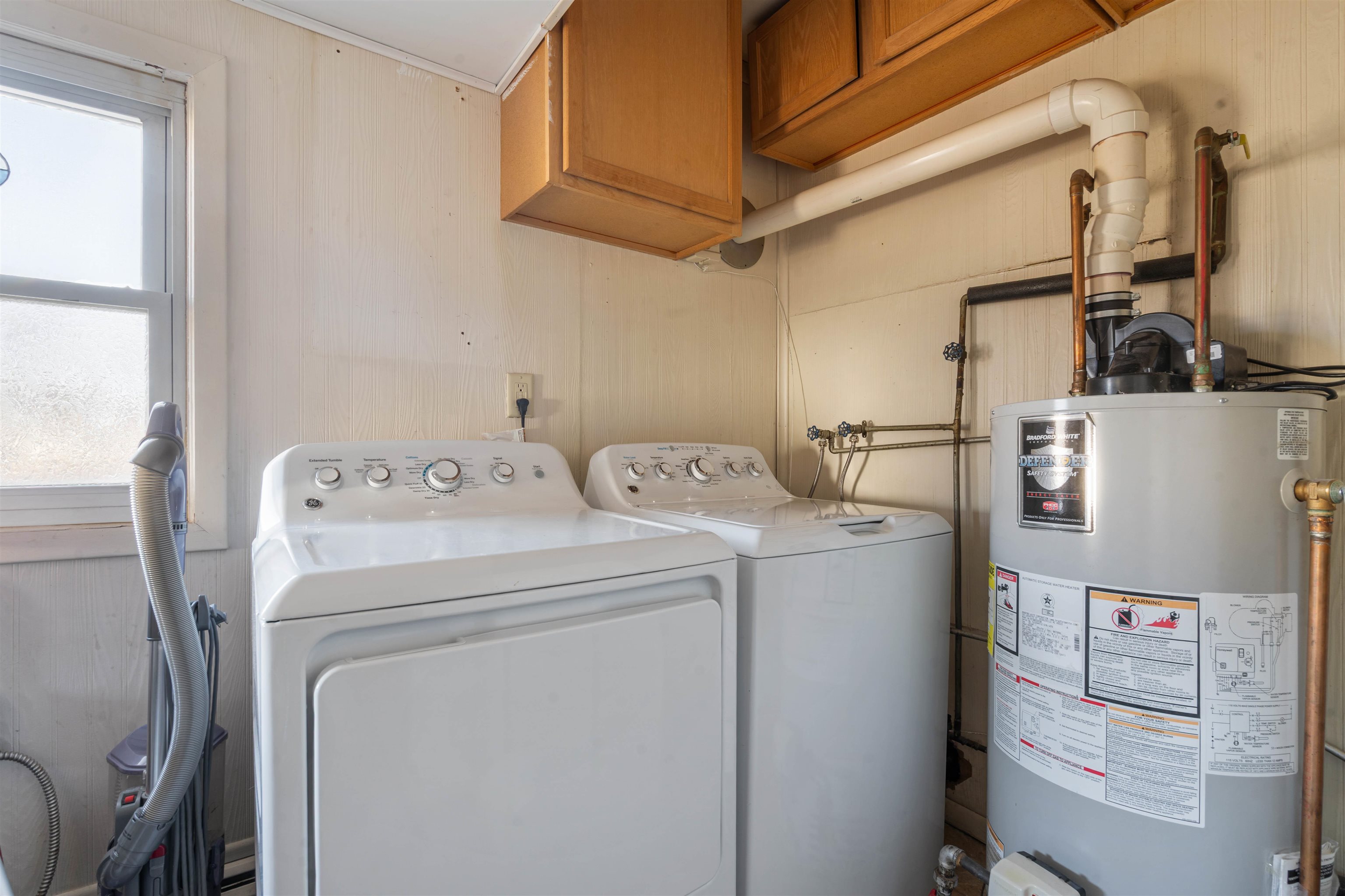 611 12th Avenue East Superior, WI 54880 - Photo 16 of 20 Laundry room featuring gas water heater, separate washer and dryer, and cabinet space