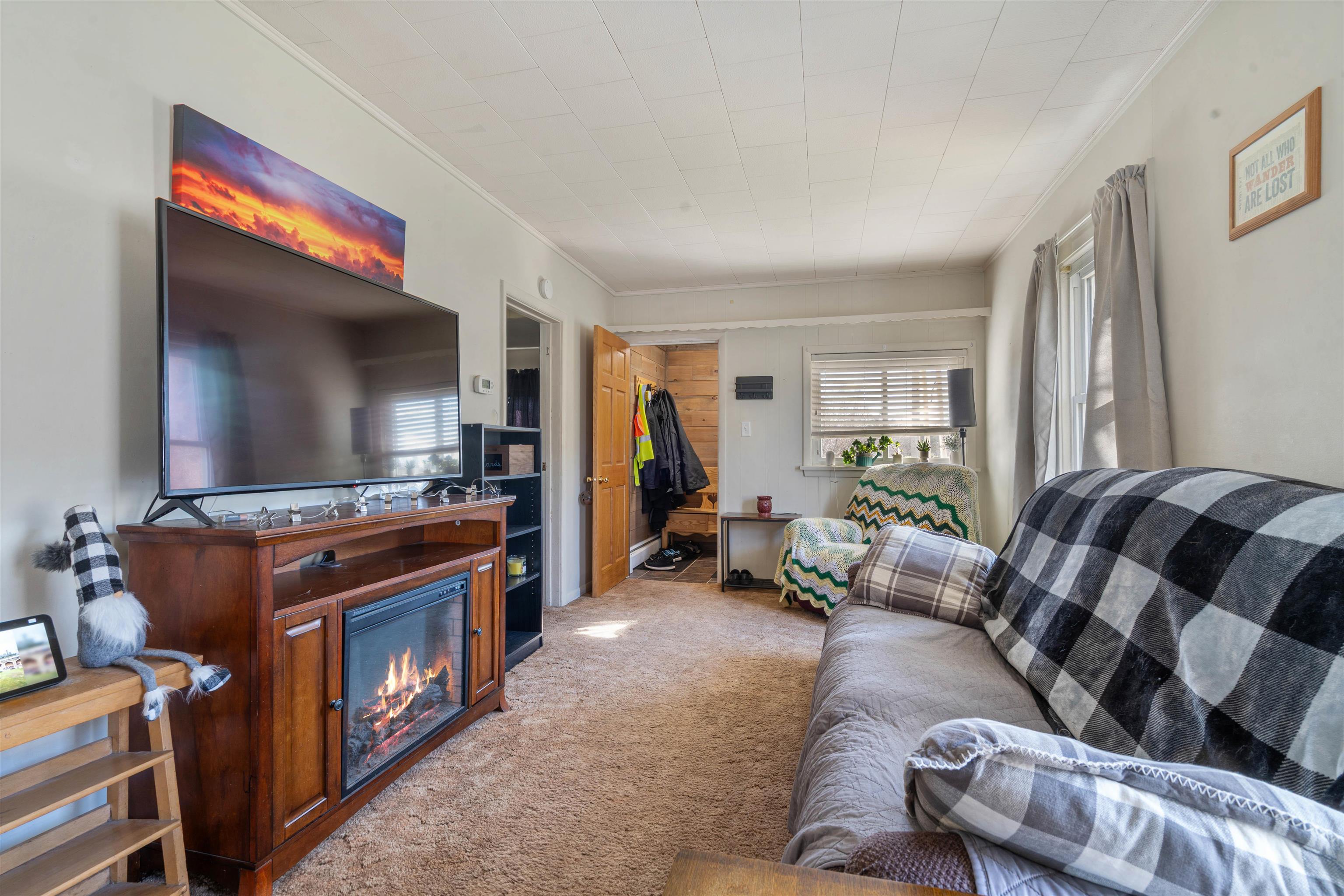 611 12th Avenue East Superior, WI 54880 - Photo 6 of 20 Carpeted living room with crown molding and a glass covered fireplace