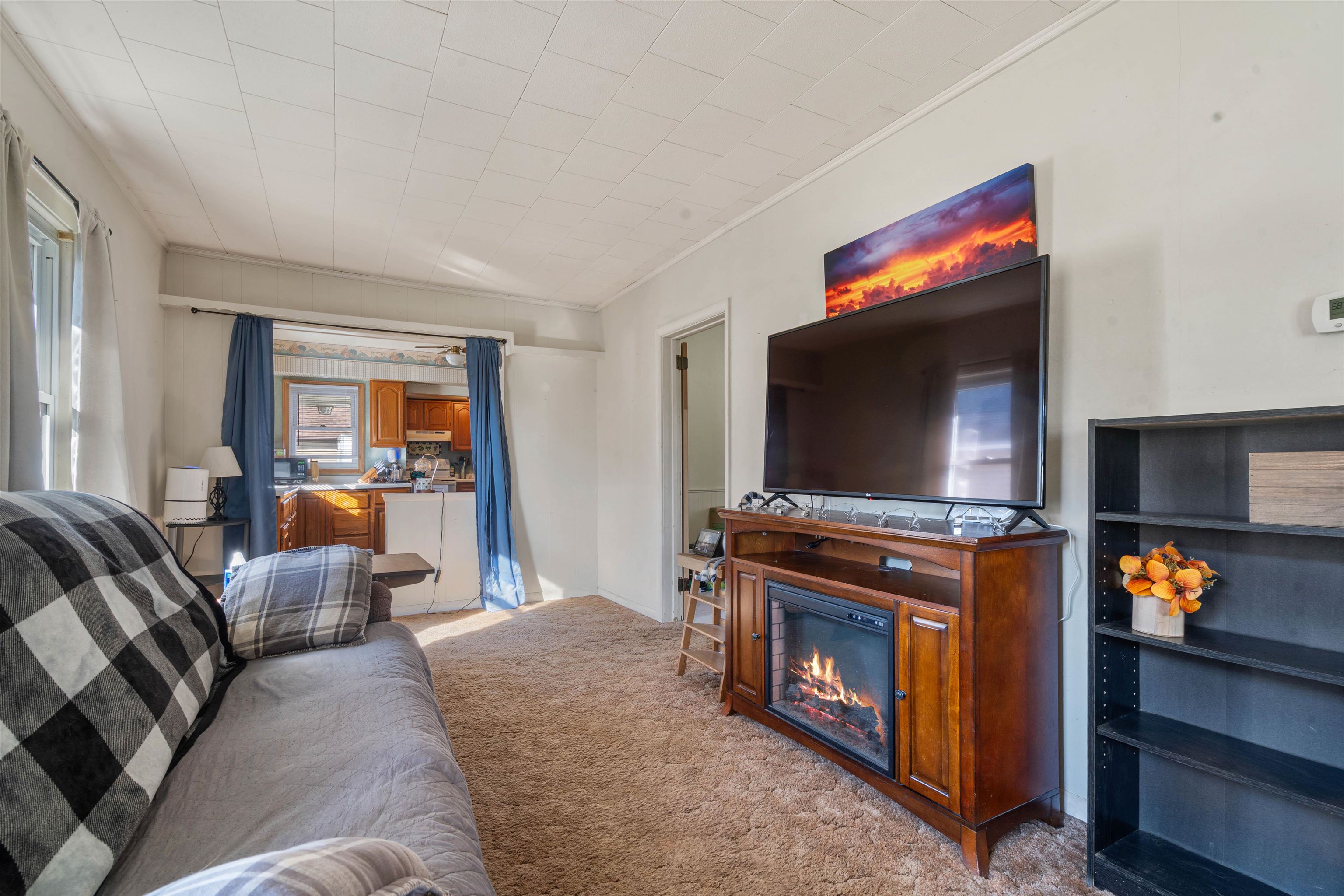 611 12th Avenue East Superior, WI 54880 - Photo 7 of 20 Living area featuring light carpet, a glass covered fireplace, and ornamental molding