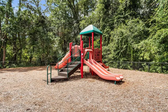 a view of outdoor space with playground and green space