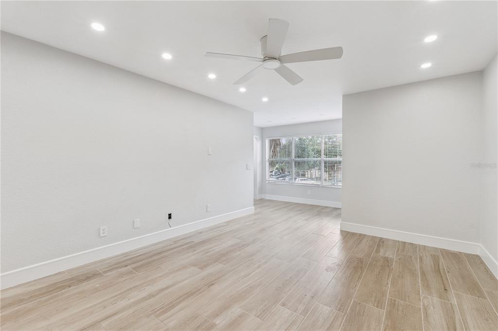 5124 Conroy Road, Unit 24 Orlando, FL 32811 - Photo 7 of 26 an empty room with wooden floor and windows