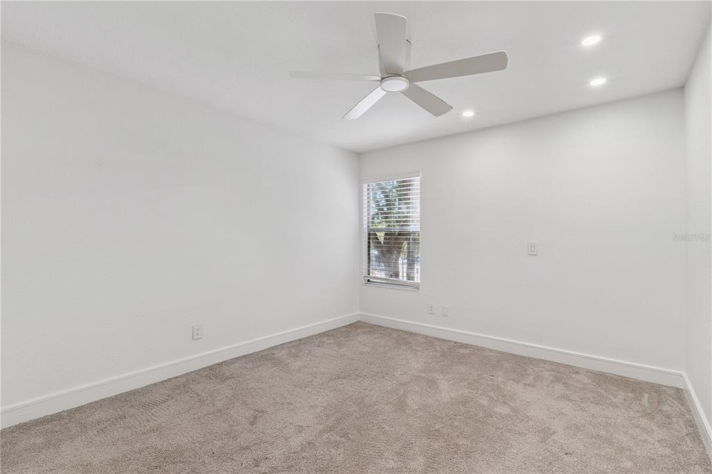 5124 Conroy Road, Unit 24 Orlando, FL 32811 - Photo 8 of 26 an empty room with windows and fan