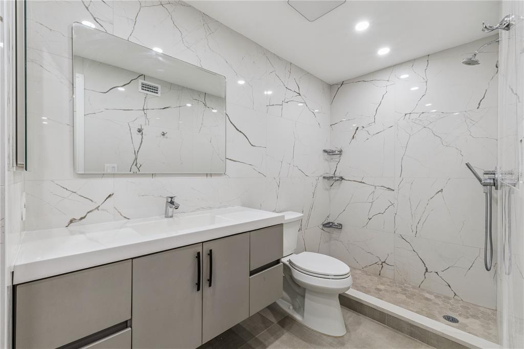 5124 Conroy Road, Unit 24 Orlando, FL 32811 - Photo 10 of 26 a bathroom with a toilet sink a mirror and shower