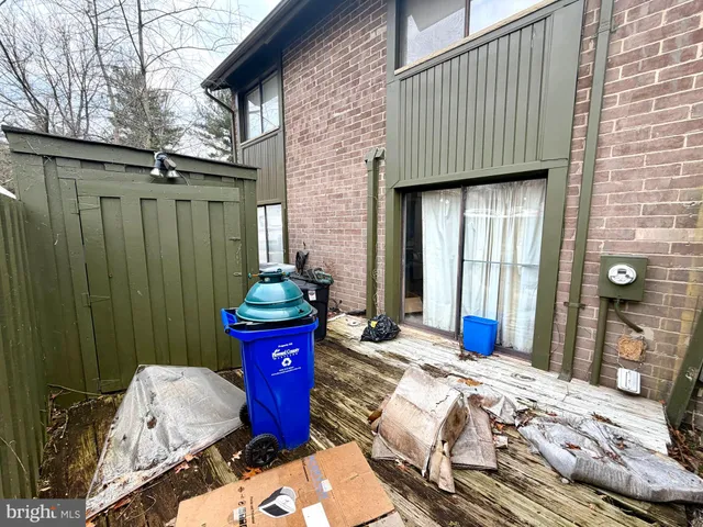 a bedroom with a bed and large windows
