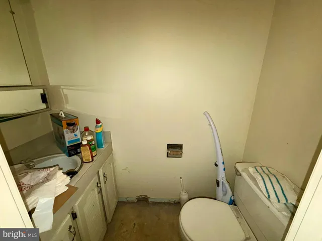a bathroom with a sink toilet and mirror