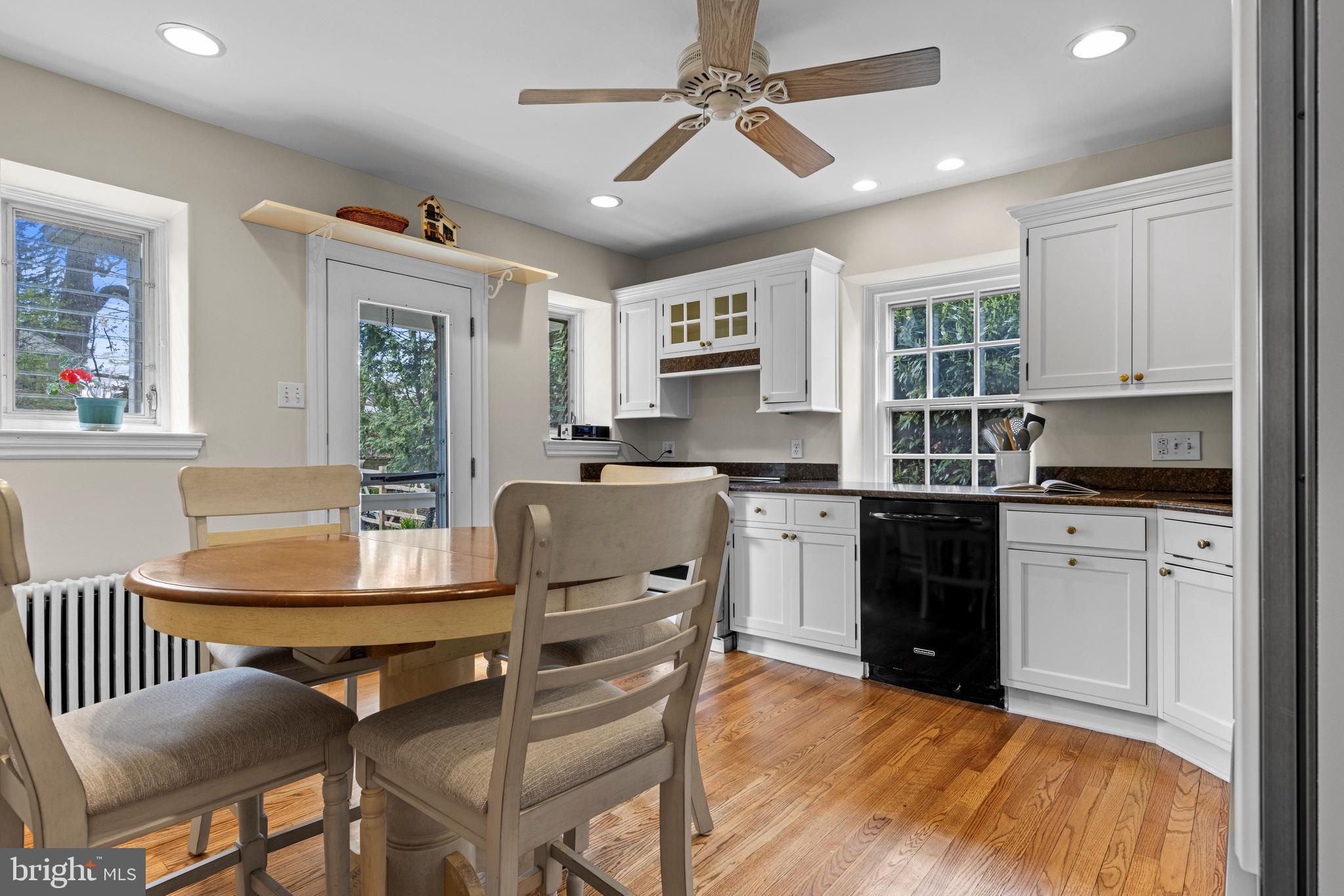 510 Anthwyn Road Merion Station, PA 19066 - Photo 12 of 30 a kitchen with granite countertop a stove a sink dishwasher a dining table and chairs with wooden floor