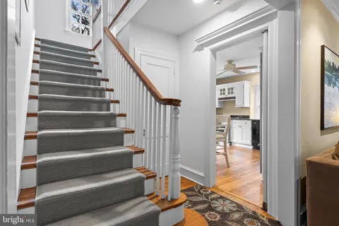 a view of entryway and hall with wooden floor