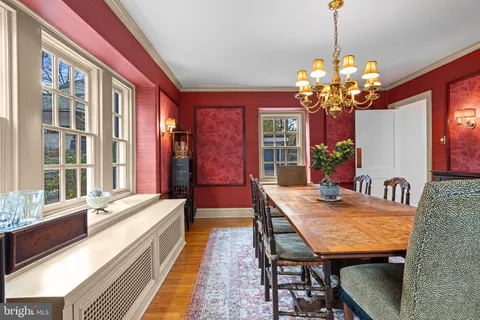 a view of a dining room with furniture a chandelier and wooden floor