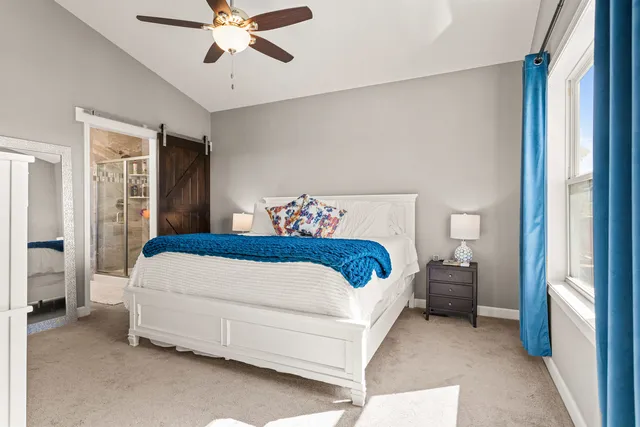 a bedroom with a large bed and a window