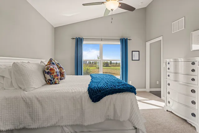a bedroom with a bed and a dresser in it