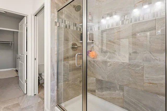 a view of walk in closet with clothes and shoes