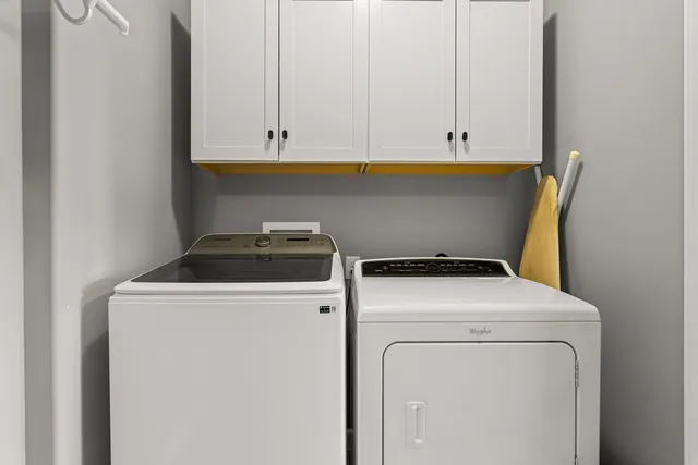 a living room with furniture and chandelier