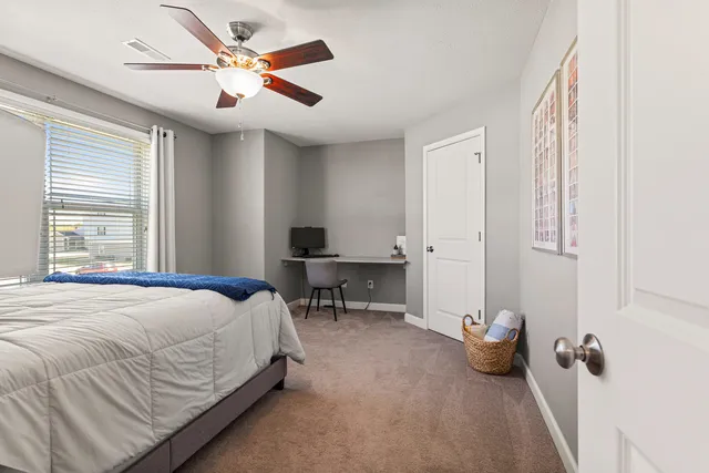 a bedroom with a bed and window