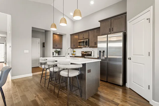 a kitchen with a sink a stove and cabinets