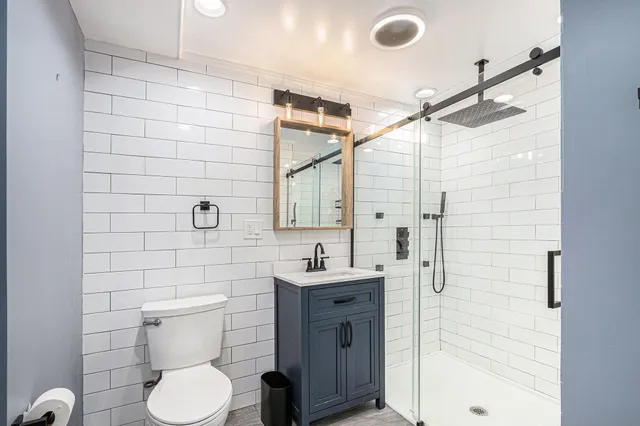 a bathroom with a sink toilet and shower