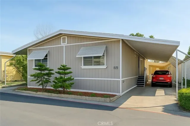 a view of a house with a small yard and plants