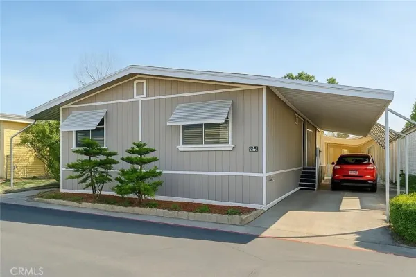 a view of a house with a small yard and plants