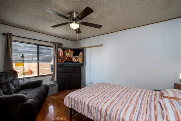 a bedroom with a bed a couch and a window