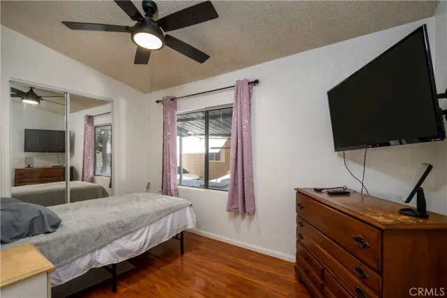 a bedroom with a bed and a flat screen tv