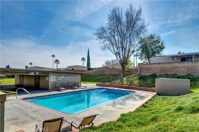 an outdoor space with swimming pool and furniture