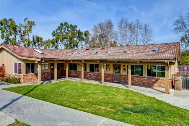 a view of a house with a yard and sitting area