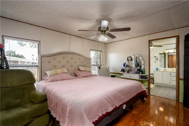 a bedroom with a bed a couch and dresser