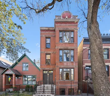 a front view of a residential apartment building with a small yard
