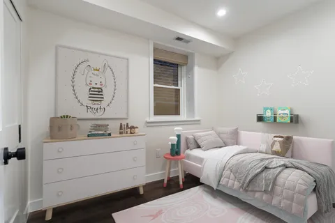 a bedroom with a bed and cabinet