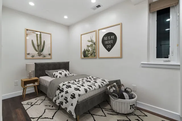 a bedroom with a bed and wall painting