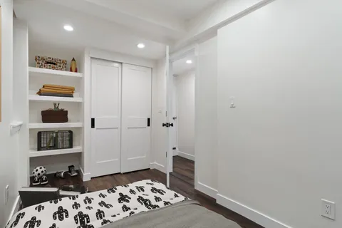 a bedroom with a bed and closet