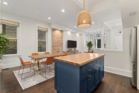 a room with table chairs and a large window
