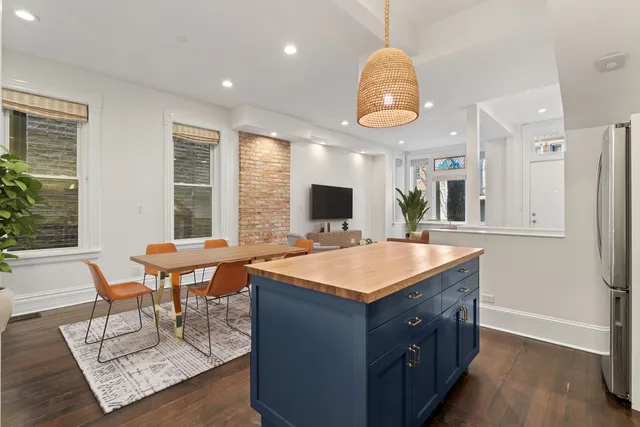 a room with table chairs and a large window