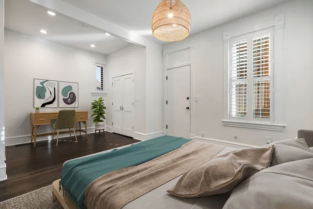 a bedroom with bed and a chandelier