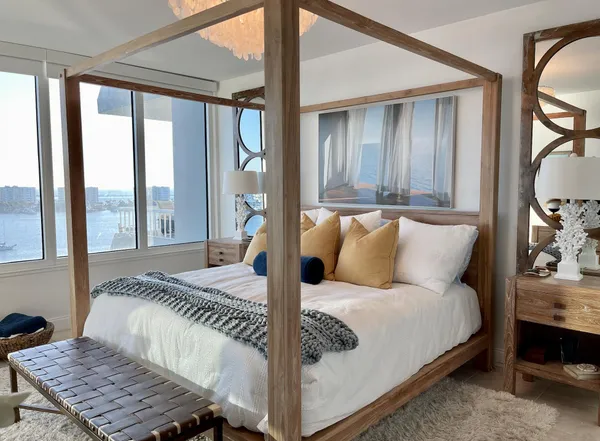 a bed sitting in a bedroom next to a window