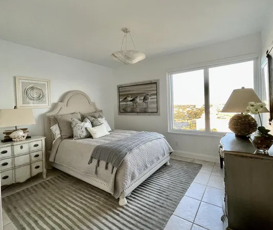 a bedroom with a large bed and a window