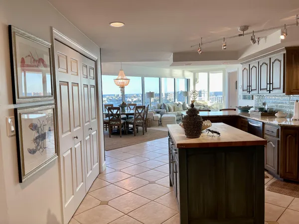a kitchen with stainless steel appliances granite countertop a sink and a refrigerator