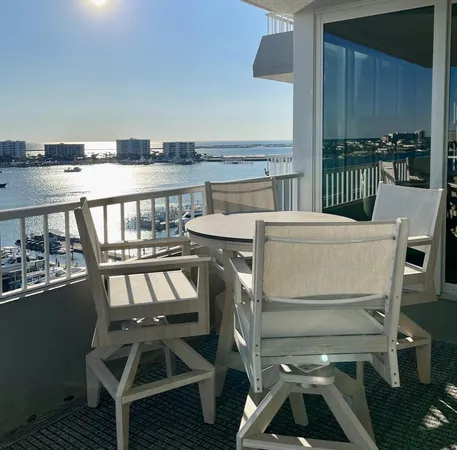 a view of a balcony dining table and chairs