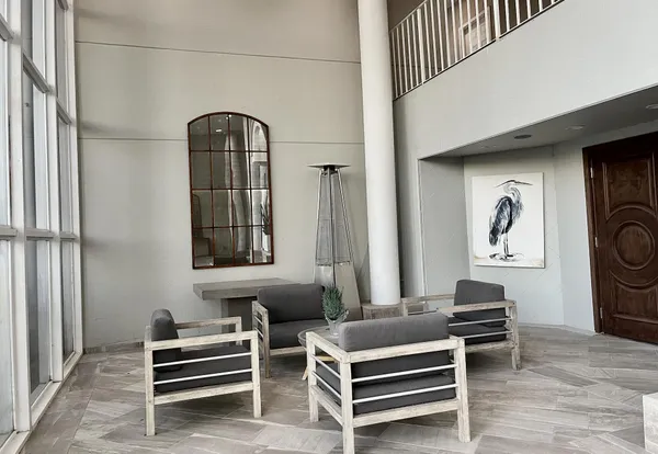 a living room with furniture a rug and white walls